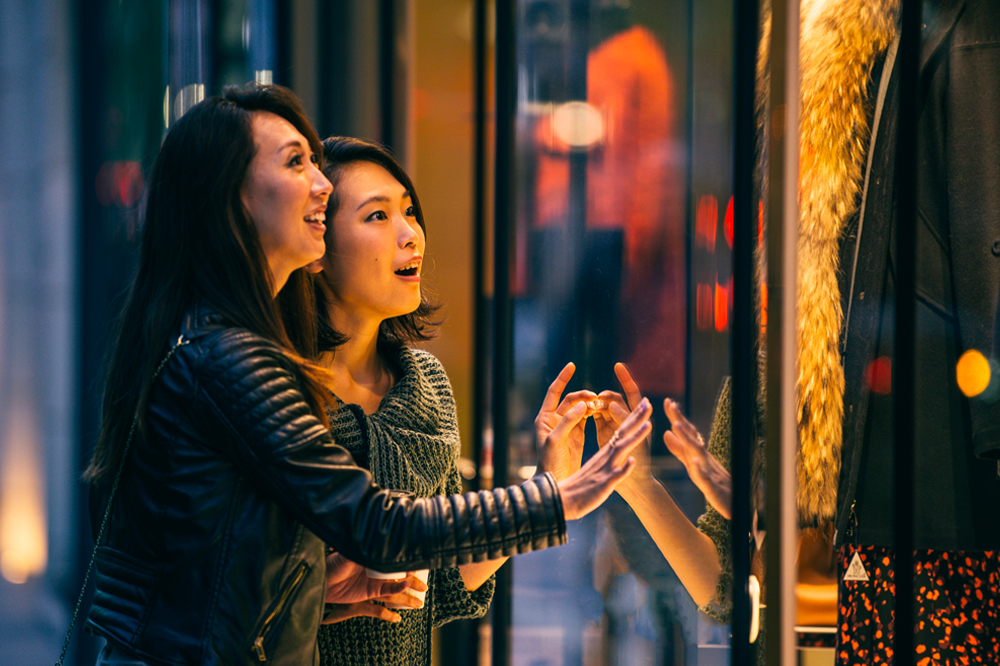 two asian women window shopping