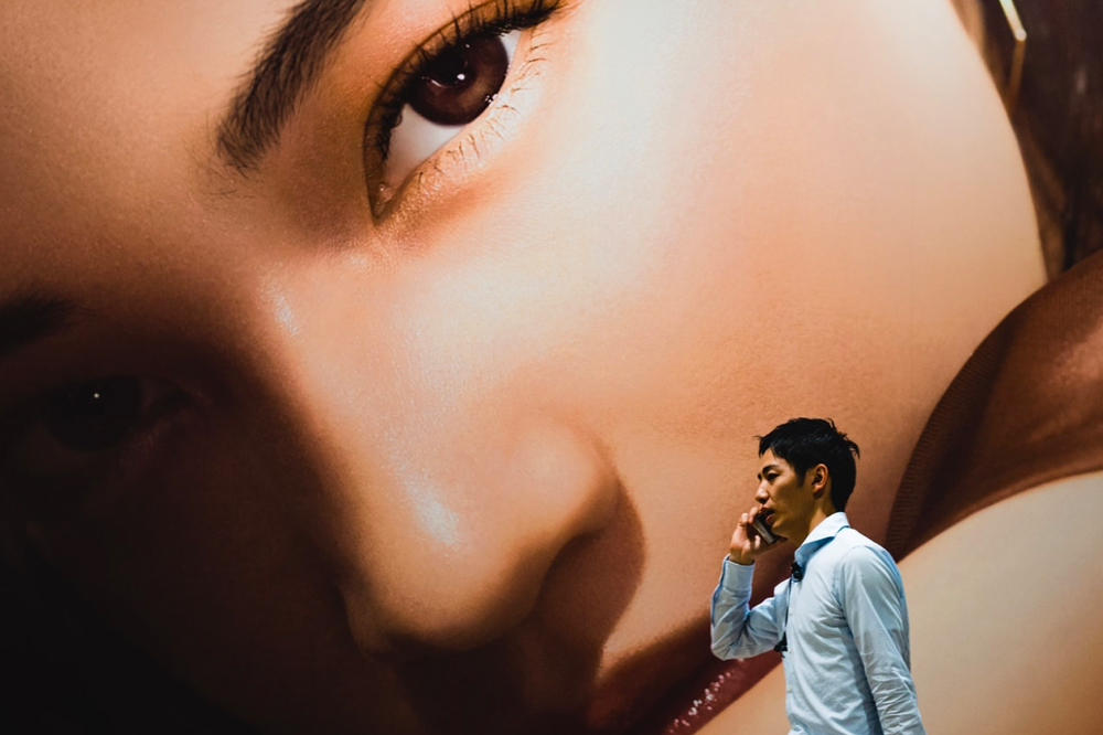 Man walking past large murial