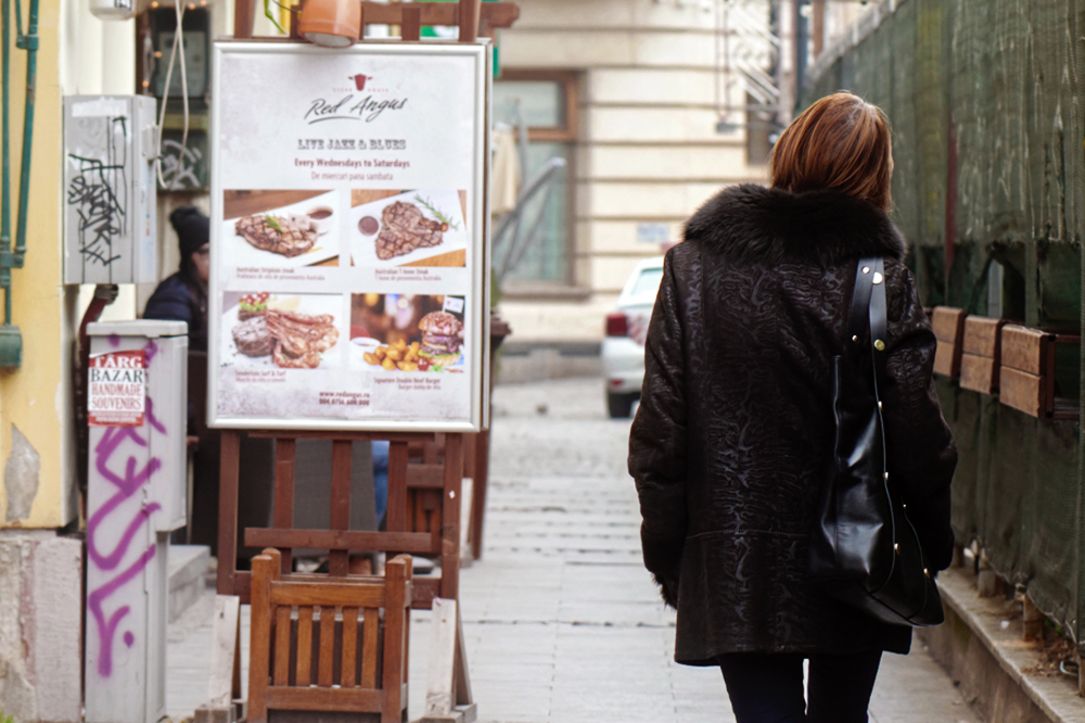 woman walking towards street ad