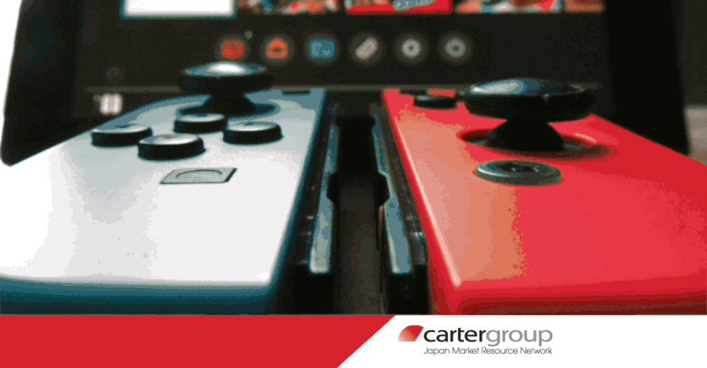 Closeup of a Nintendo Switch controller in front of a monitor for use as the header of a blog about gaming platform sensitivities on carterjmrn.com